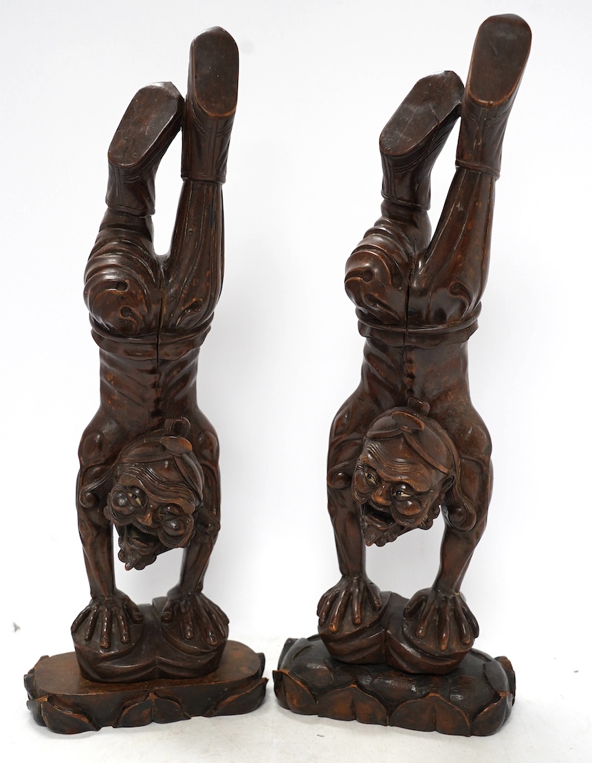 Two Chinese carved rosewood figures of acrobats, 42cm high. Condition - fair to good, polish worn in places